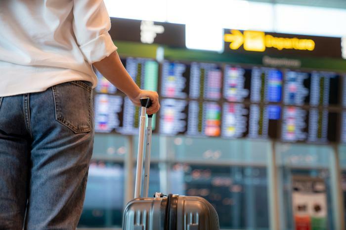Person in airport looking at departure list
