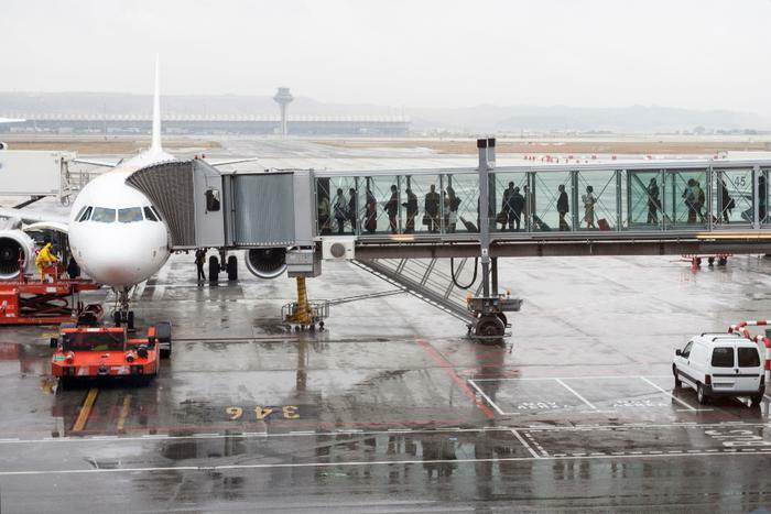 Airline passengers boarding plane