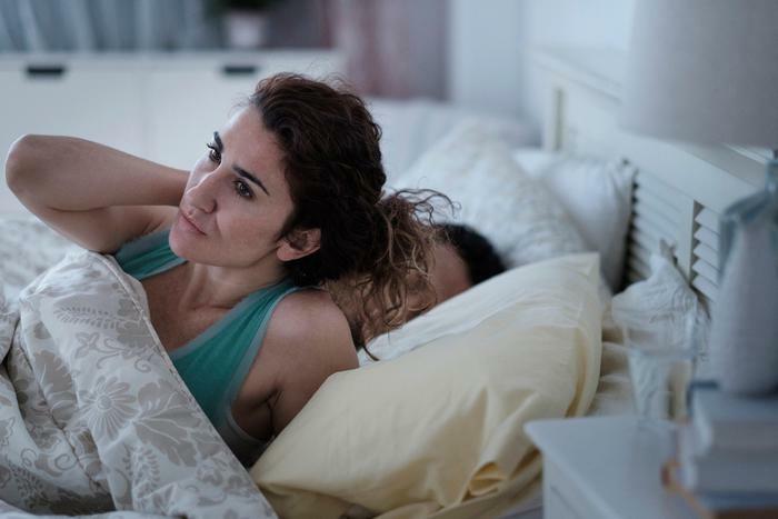 Anxious woman in bed