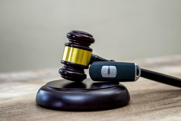 Automotive lawsuit concept with key and gavel