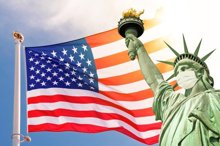COVID-19 concept with U.S. flag and Statue of Liberty