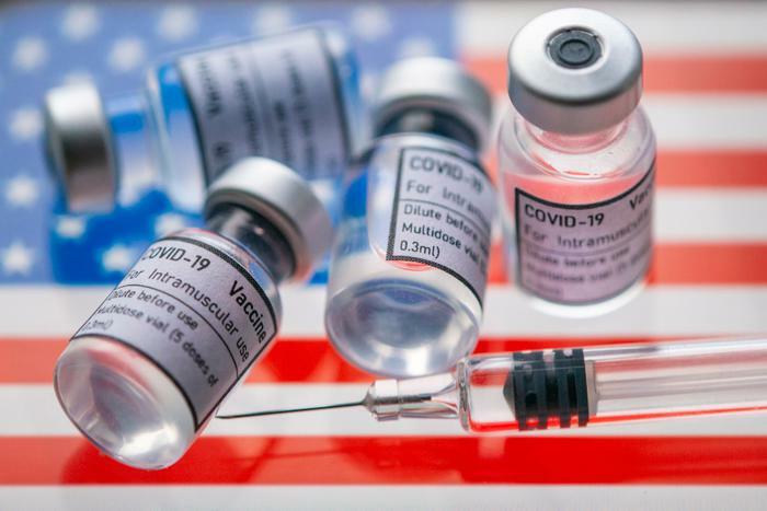 COVID-19 vaccine vials on U.S. flag concept