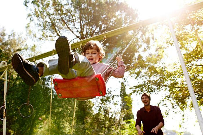 Child on swingset in park