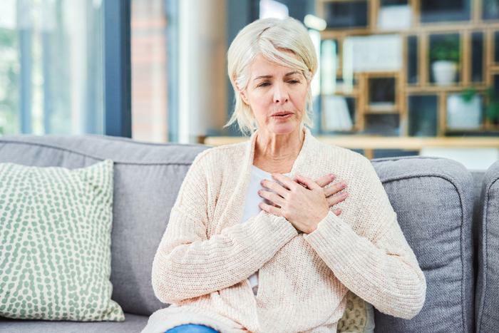 Concerned older woman with hand on chest