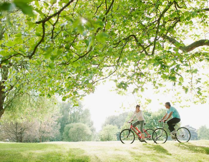 Couple biking in outdoor green space