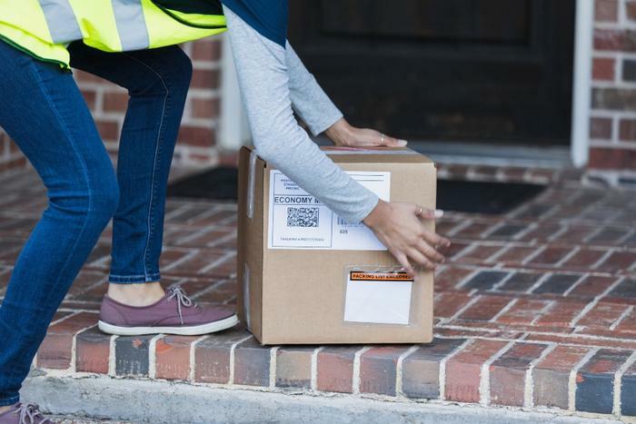 Delivery person putting package on doorstep
