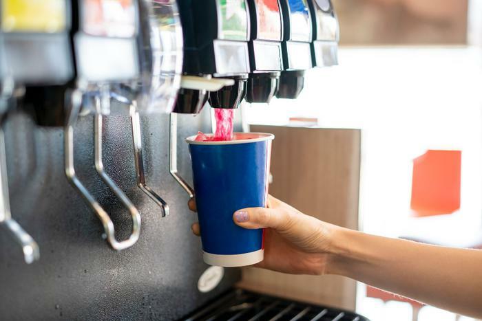 Dispensing sugary drink or soda into cup