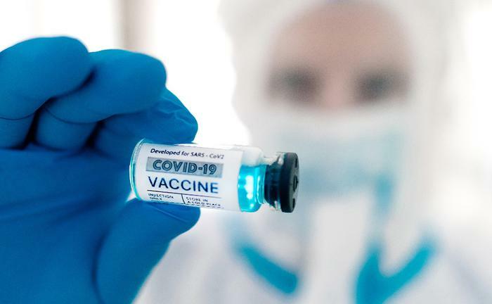 Doctor holding a COVID-19 vaccine