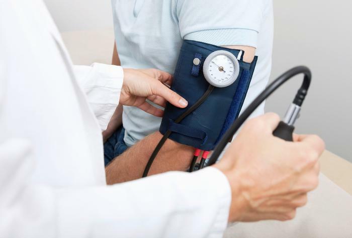 Doctor taking blood pressure reading