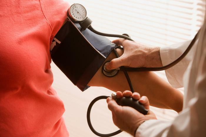 Doctor taking blood pressure reading