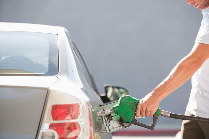 Man pumping gas in car