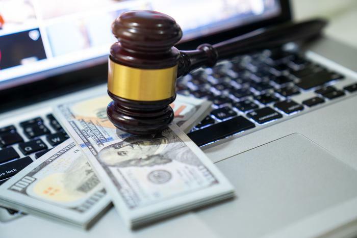 Gavel and money on laptop