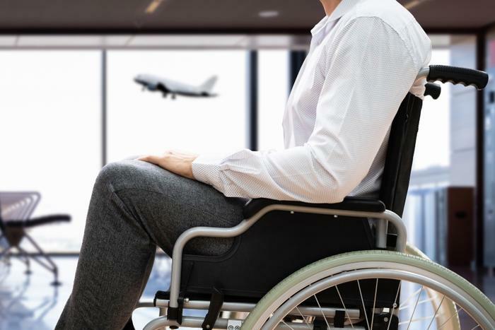 Man in wheelchair at airport