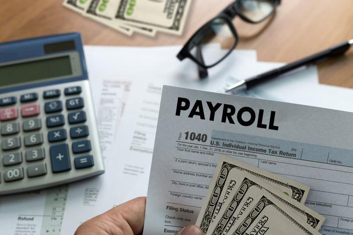 Payroll taxes concept with money