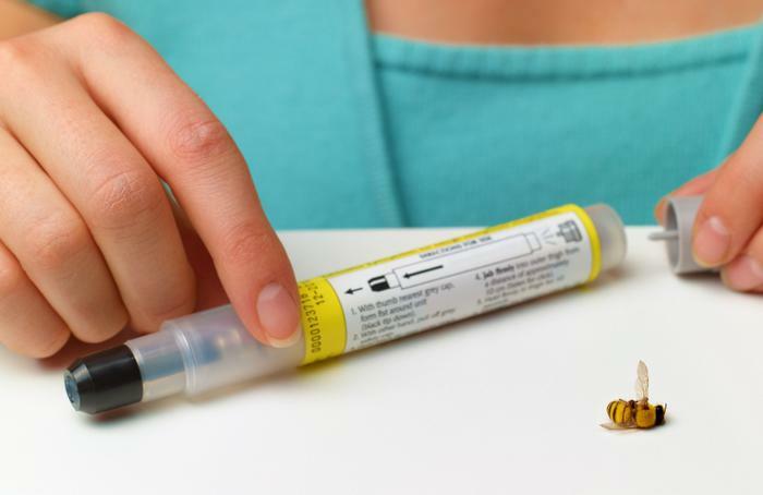 Person preparing EpiPen after wasp sting