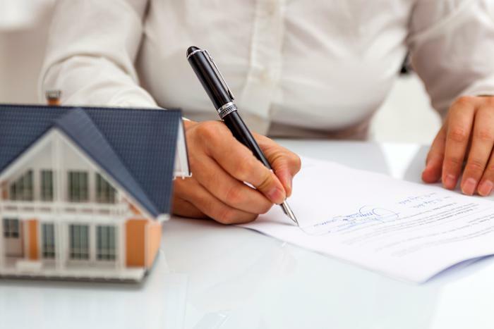 Person signing home contract