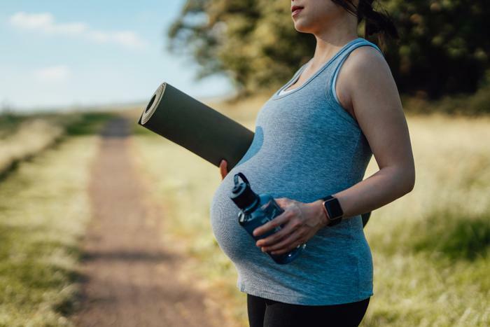 Pregnant woman exercising outside