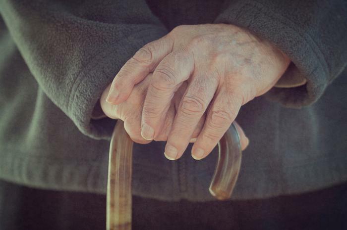 Senior man holding cane