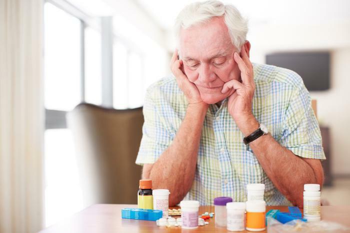 Senior man looking at medication
