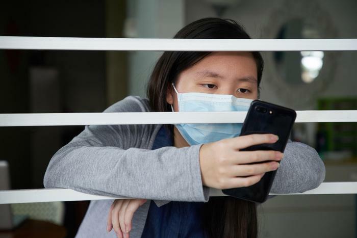 Teen girl on phone during COVID-19 pandemic