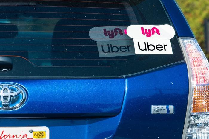 Uber and Lyft stickers on car