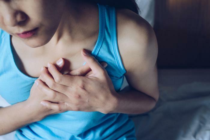 Woman having chest pain or heart attack