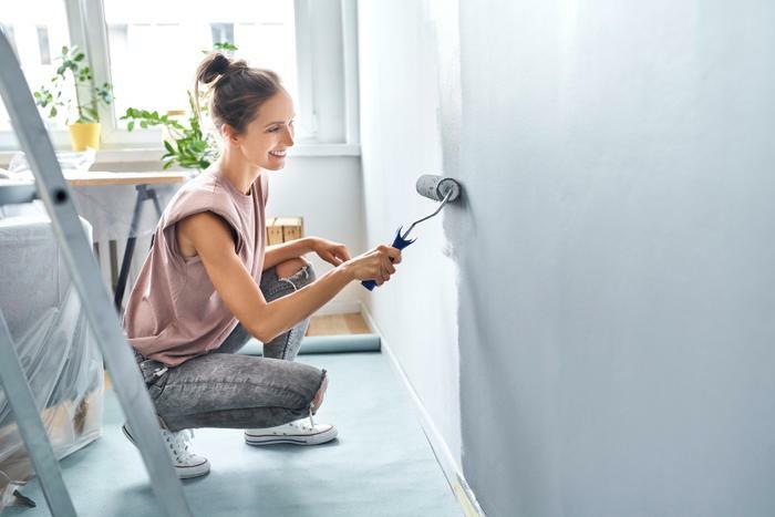 Woman painting inside home