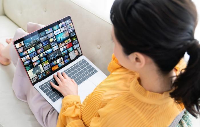 Woman streaming content on laptop