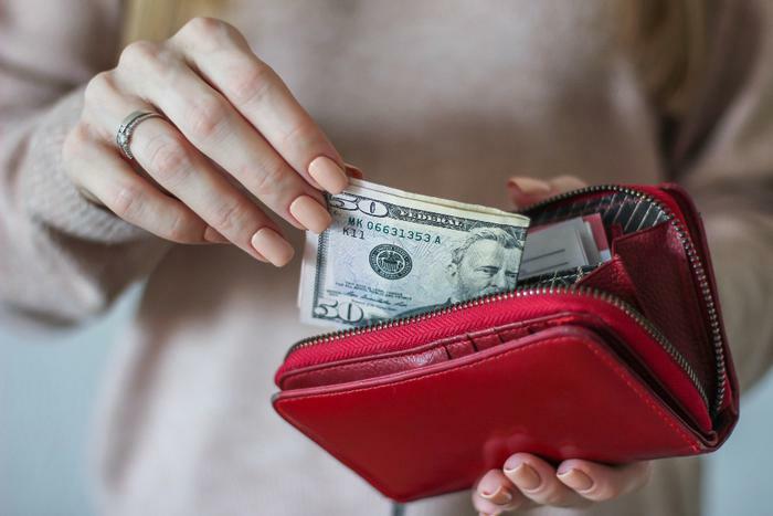 Woman taking money from purse
