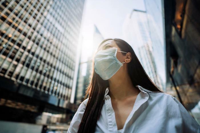 Woman wearing COVID-19 mask in city