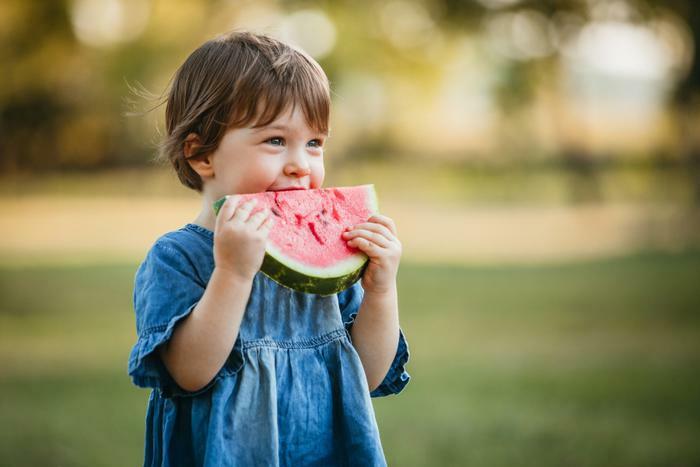 Young child eating watermelon