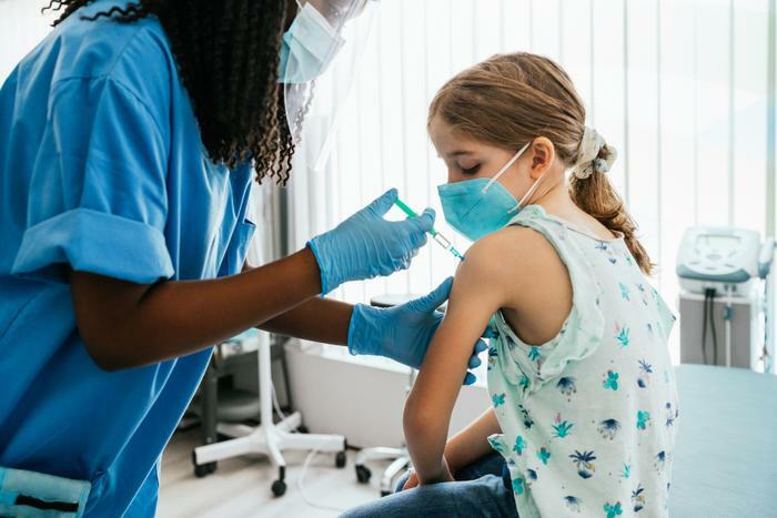 Young girl receiving COVID-19 vaccine