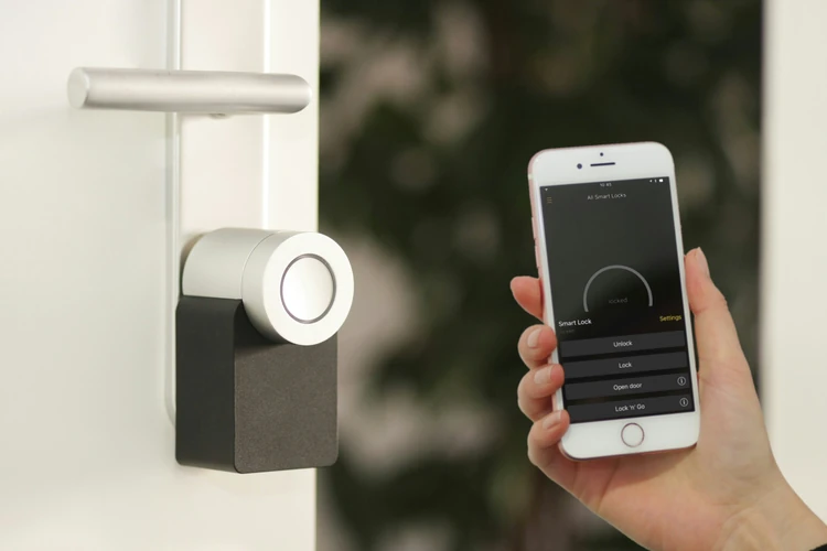 “an image of someone using a smart lock on their door.