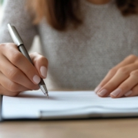 a woman signing papers