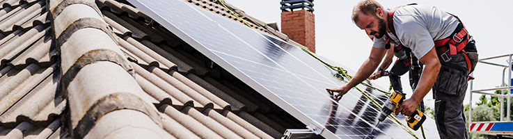technicians installing solar panels