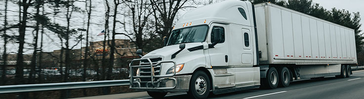 white moving truck on the road