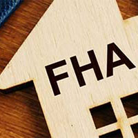 small wooden house with fha loan engraved