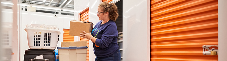 woman moving her belongings into a self-storage unit