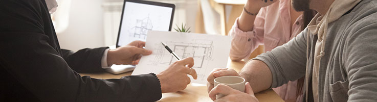 architect presenting house plan to a couple