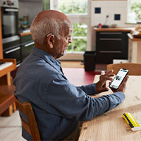 older man checking cell phone