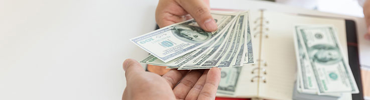 man handing money to another man