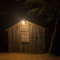 wooden shed with light at night
