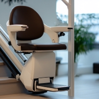 a white stairlift at the bottom of some stairs
