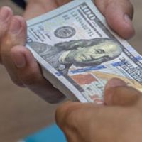 man giving money to another man