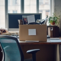 a box on an office table with personal effects in it