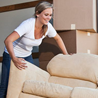 man and woman moving a couch