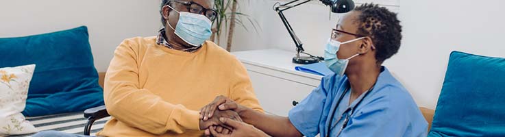 caregiver talking to senior patient