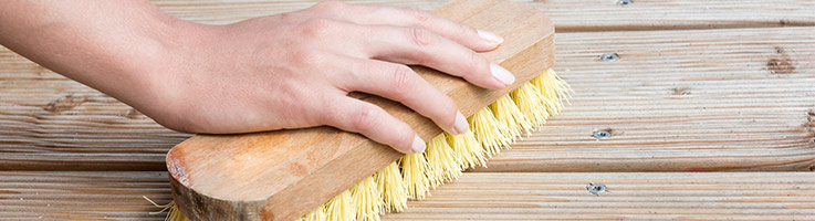 hand scrubbing a wooden deck