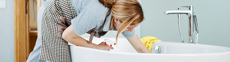 woman cleaning a bathtub