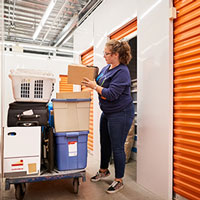 woman moving her belongings into a self-storage unit